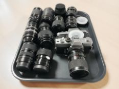 A Minolta SRT101 camera body with Tokina 28-85mm lens, a further Konica Auto Reflex T3 camera body,