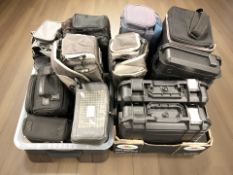 A quantity of camera bags and hard shell cases.