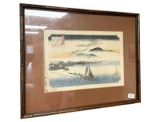 A 20th century hand coloured Japanese print depicting fishing boats on water, 39 cm x 26 cm.