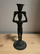 An African patinated metal figural candlestick, height 16 cm.