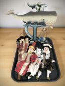 A group of puppets, a small umbrella and a tin plate model of a whale.