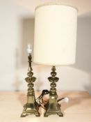 A pair of brass table lamps, one with shade, height 94 cm.