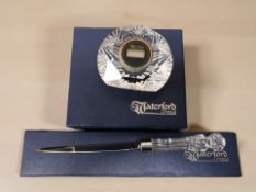 A Waterford Crystal digital timepiece and a further letter knife, both boxed.