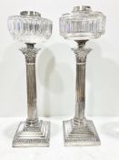 A pair of silver Corinthian column oil lamp bases,