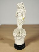 A composition figure of a nude lady standing on an oyster shell, on ebonised plinth, height 60 cm.