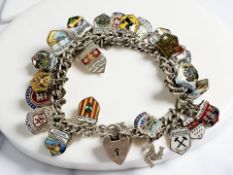 A silver charm bracelet with enamelled town crests CONDITION REPORT: 47g