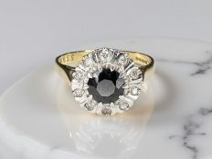 An 18ct gold sapphire and diamond cluster ring, size N CONDITION REPORT: 3.