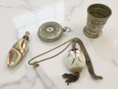 A pocket watch containing a telescopic cup, and two ceramic scent bottles.