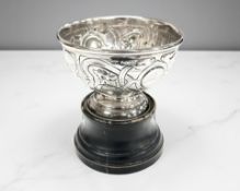 A silver cup on ebonised stand, Chester 1901, height 12cm.