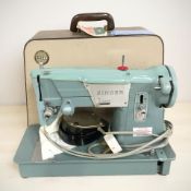 A Singer electric sewing machine, with lead and pedal.