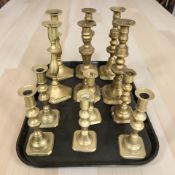 Several pairs of Victorian brass candlesticks.