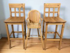 A pair of modern pine high chairs and a child's high chair.