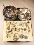 An assortment of costume and silver jewellery including various decorative brooches and earrings,