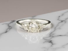 An antique 18ct white gold diamond ring, the central diamond approximately 0.