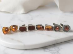 Three pairs of silver and amber cuff links,