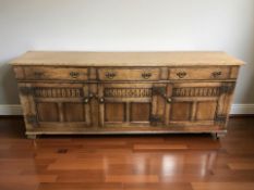 A reproduction oak low sideboard in the Georgian style,