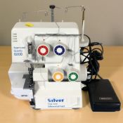 A Silver free arm differential feed electric sewing machine, with lead and pedal.