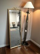 A wrought metal standard lamp and a gilt and bevelled rectangular mirror, height 133 cm.