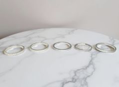 Five silver eternity/half-eternity rings.