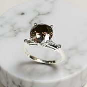 A platinum diamond solitaire ring, the cognac brown brilliant cut diamond weighing 3.