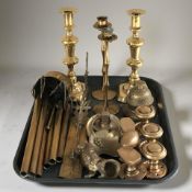 A group of brass candlesticks, door knocker and knobs, an eastern wind chime, figure of a dog, etc.