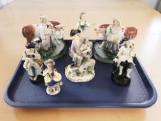 A pair of 19th century Staffordshire figures of a lady and gentleman milking cows,