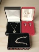 A silver chain with tree of life pendant, a further white stone set pendant,