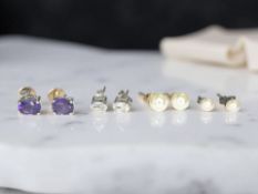 A pair of silver amethyst stud earrings, a silver and white topaz pair,