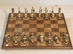 A wooden chess board and set of brass chess pieces, kings 7 cm.