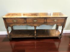 A George III style oak three drawer dresser base,