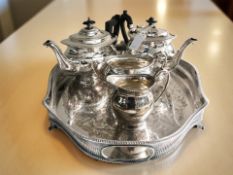 An EPNS four-piece tea service and a galleried twin-handled serving tray, width 52 cm.