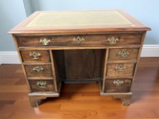A George III mahogany and oak seven drawer kneehole writing desk,