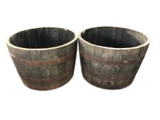 A pair of coopered oak barrel planters,