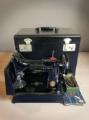 A Singer featherweight electric sewing machine with lead and pedal,