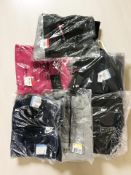 A group of Nike clothing including lady's and children's tracksuit tops and joggers.