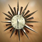 A Metamec brass and teak sunburst wall clock, diameter 60 cm.