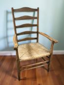A 19th century oak farmhouse ladder back armchair with rattan seat.