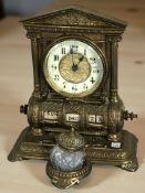 An ornate brass desk clock / calendar, height 22 cm.