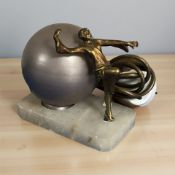 An Art Deco alabaster and gilt metal table lamp surmounted by a dancing lady, height 15 cm.