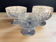 An Edinburgh Crystal footed fruit bowl, diameter 19 cm, and two larger similar fruit bowls.