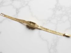 A 9ct yellow gold lady's Accurist wristwatch on 9ct gold integrated bracelet.