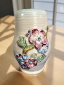 A Clarice Cliff for Newport Pottery ribbed floral vase, height 15.5 cm.