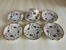 A Royal Crown Derby Royal Antoinette porcelain tea cup and six saucers in the same pattern.