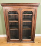 A Victorian mahogany double door cabinet with shelved interior,
