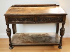 An early 20th century carved oak two drawer side table, 106 cm x 46 cm x 79 cm.
