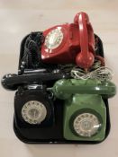 Three vintage plastic telephones.