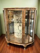 An Art Deco walnut serpentine front display cabinet, 102 cm x 38 cm x 116 cm.