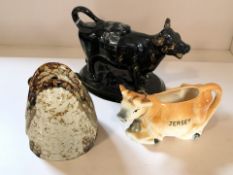 A Victorian Jackfield Ware cow creamer and lid, a 20th century Jersey cow creamer,