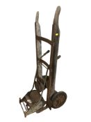 A vintage sack barrow and a garden push along mower / roller.