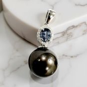 A 14ct white gold pearl, sapphire and diamond pendant, the oval-cut sapphire weighing 0.